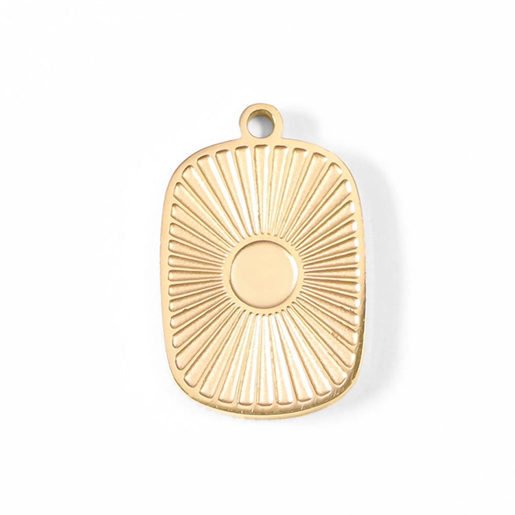 Gold sunburst medallion charm on a white background