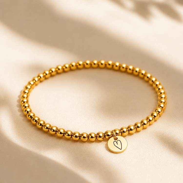 Custom Gold beaded bracelet with a heart charm engraved