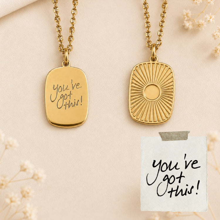 Gold medallion necklace engraved with handwritten 'you've got this!', shown front and back beside the original note