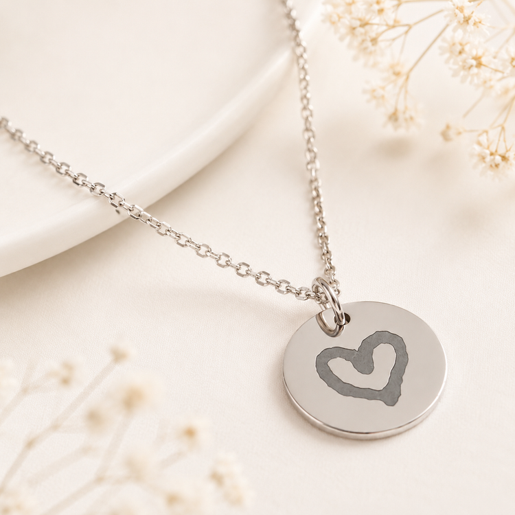 Personalised Silver necklace with a heart-shaped pendant on a soft background
