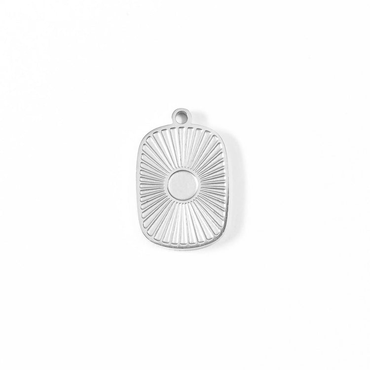 Silver sunburst medallion charm on a white background