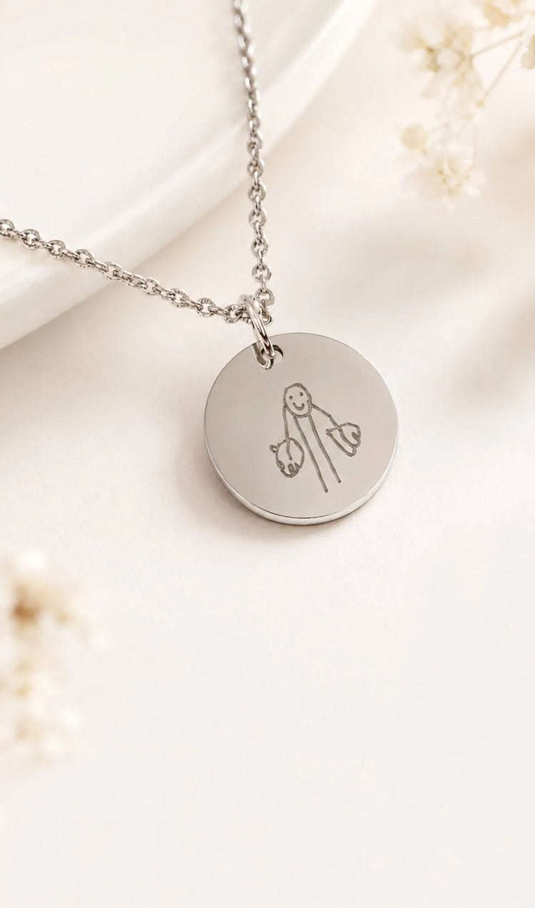 Close-up of engraved kid's drawing engraved on custom jewellery