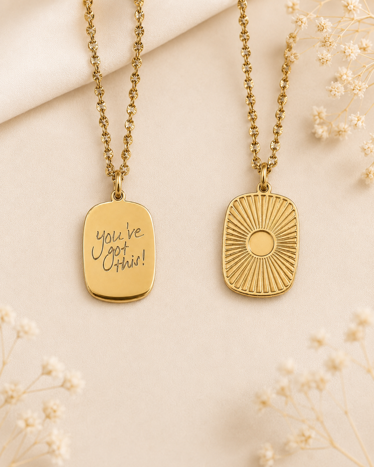 Gold medallion necklaces showing the engraved handwriting side and the sunburst side