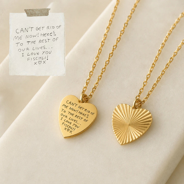 Gold heart pendant engraved with a full handwritten letter, shown beside the original note